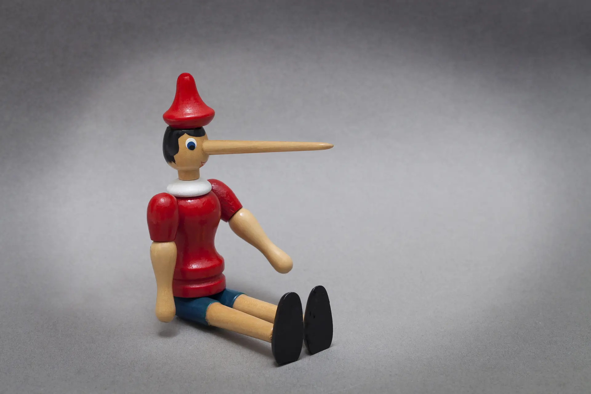 A wooden puppet figure, used here to illustrate the concept of a 'lie' in the framework's name